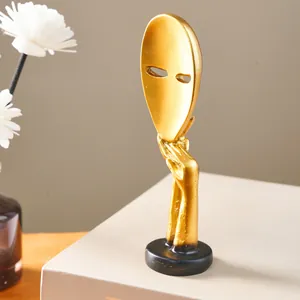 Close-up of golden abstract mask sculpture Silence is Golden for Nordic home decor