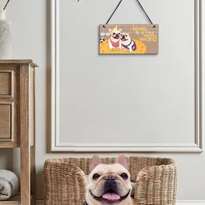 Detail of wooden pet-themed hanging plaque in a cozy home setting with a French Bulldog.