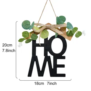 Dimensiones detalladas del adorno de pared HOME de madera con verde y lazo de yute
