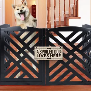 Close-up of wooden pet door sign with A Spoiled Dog Lives Here text on a gate