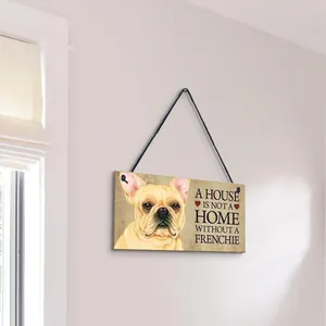 Detail showing a wooden plaque with a French Bulldog illustration and home decor quote