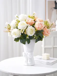 Detail of realistic white and peach artificial multi-head roses in a stylish bow vase