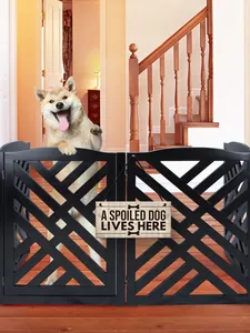 Wooden dog hanging sign A Spoiled Dog Lives Here on a pet gate in a home setting