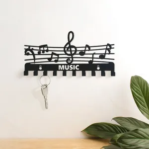 Minimalistischer schwarzer Metall-Schlüsselhaken mit Noten-Design, ideal für Wanddekoration.