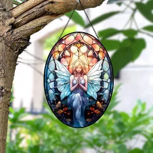 Stained glass style acrylic fairy hanging ornament displayed outdoors on a tree