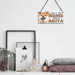 Detail view of Akita dog illustration and text on wooden hanging plaque