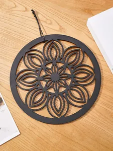 Exquisite black wooden wall art with intricate mandala pattern and cord for boho home decor.