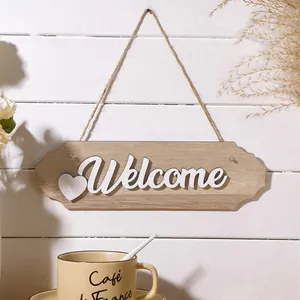 Detailed macro view of a rustic wooden 'Welcome' sign with a 3D white heart design.