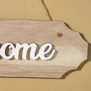 Macro view of a rustic wooden welcome sign showing detailed wood grain and natural twine