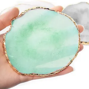 Macro detail of a green resin agate-style palette featuring a textured gold-plated rim