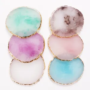 Detail view of colorful resin nail art palettes with decorative gold edges