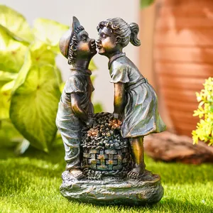 Vintage resin garden statue showing a boy and girl kissing over flower basket detail