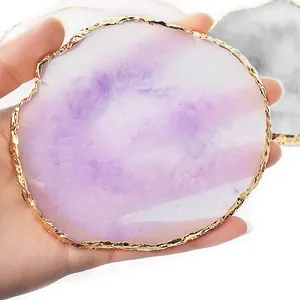 Detailed view of a purple resin agate palette with irregular gold rim for nail art