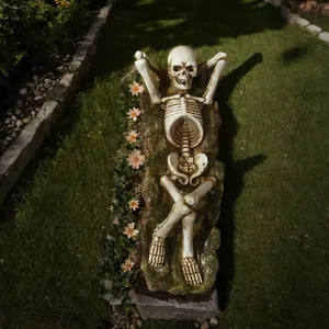 Detailed view of Gothic skeleton figurine with mossy base lying flat for garden or desk decor