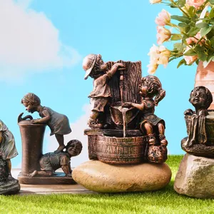 Detailed view of retro resin garden sculptures featuring children playing with water