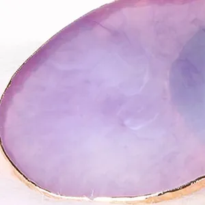 Close-up detail of resin nail palette with gold edge and purple agate texture
