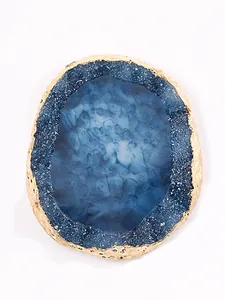 Detail view of blue resin agate palette with irregular gold foil edge texture