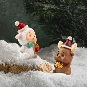 Vista detallada de figuritas navideñas de cordero y reno en una escena nevada