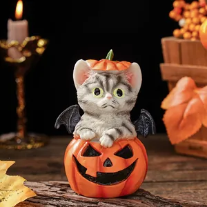 Halloween grey cat resin figurine with bat wings in pumpkin bucket for holiday desktop decor detail.