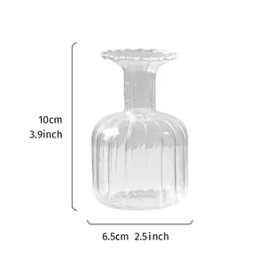Detail of ribbed clear glass vase with 10cm height and 6.5cm width measurements