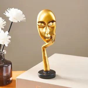 Close-up of golden abstract face sculpture Silence is Golden for Nordic home decor