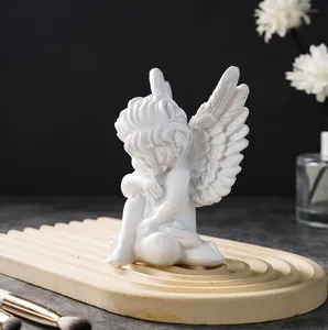 Detailed view of a white resin sleeping cherub angel figurine for elegant home decor