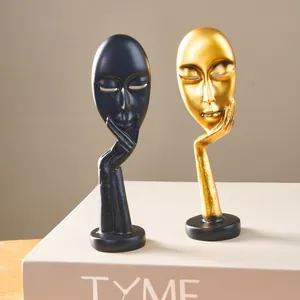 Nordic abstract face sculptures 'Silence is Golden' in gold and black resin