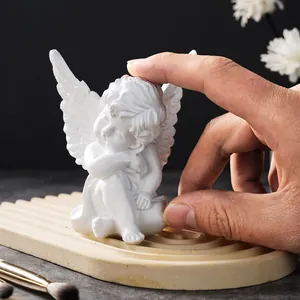 Detailed macro shot of a minimalist white resin cherub angel figurine for home decor.