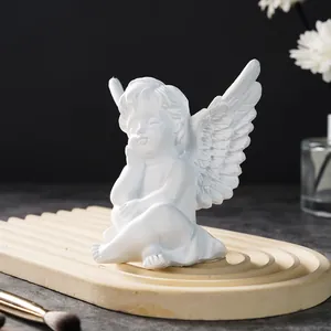 Detailed macro shot of white resin cherub angel wings and peaceful facial expression
