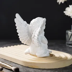 Detailed back view of white resin angel figurine showing intricate wing texture