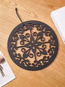 Details of the bohemian round wooden carved wall decor pendant showing exquisite floral hollow design.