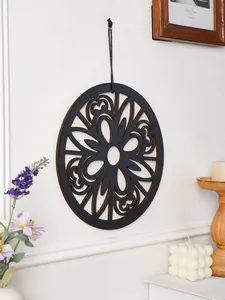 Bohemian wooden wall decor detail showing carved hollow circle artwork on white background.