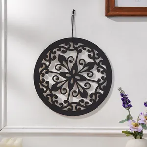 Bohemian round wooden wall hanging decor with hollow carved floral pattern for home art.