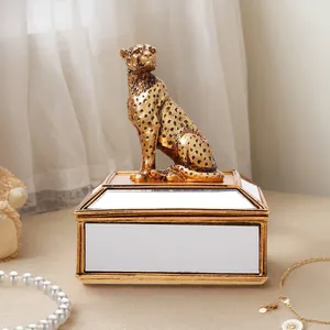 Vue détaillée de l'élégante figurine de guépard doré sur une boîte à bijoux en miroir