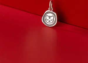 Macro detail of antique S925 silver tiger head charm for DIY jewelry making.