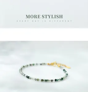 Close-up of a natural moss agate bead bracelet with a gold-plated adjustable clasp