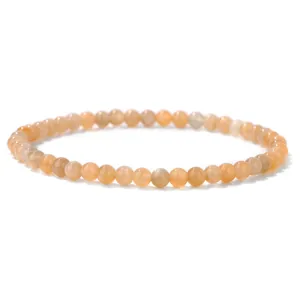 A detailed view of a 4mm natural orange stone beaded bracelet with glossy finish