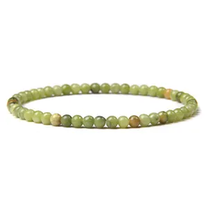 Detailed macro view of a 4mm green aventurine beaded bracelet with natural stone textures