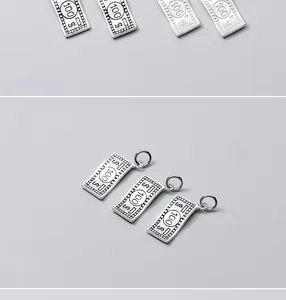 Macro view of sterling silver $100 bill charms for DIY jewelry bracelets and necklaces