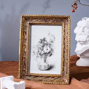 Detail of vintage ornate resin photo frame with classical floral carvings and flower sketch.