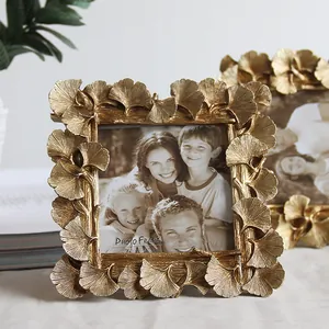 Detail view of golden gingko leaf photo frame with an intricate leaf texture