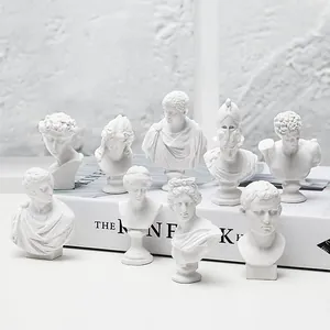 Selection of mini Greek mythological bust sculptures in a minimalist white setup