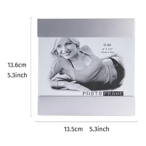 Minimalist silver metal and glass photo frame detail showing 13.5cm x 13.6cm dimensions