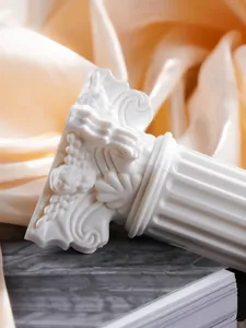 Detailed close-up of white Nordic Roman column candle holder ornament on silk background