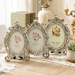 Close-up of three ornate vintage oval photo frames in different sizes for home decor.