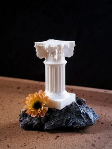 Miniature white Roman column decorative pillar arranged with a flower and stone