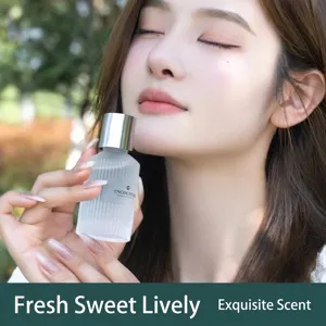 Elegant frosted glass bottle car perfume diffuser held by a model, premium aromatherapy