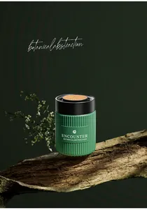Detail of green ribbed car fragrance canister on natural bark with forest theme.