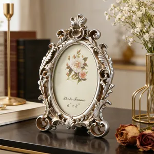 Detailed view of an ornate vintage oval photo frame with silver floral carvings