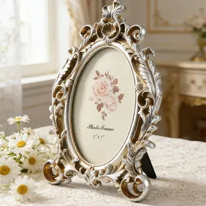 Close-up of ornate silver and gold vintage oval photo frame with 5x7 inch display size